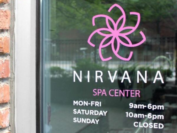 Nirvan Spa Center With Timing on a Glass Door